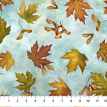  This fabric is from the Stonehenge Autumn Splendor collection for Northcott fabrics designed by Linda Ludovico. The fabric is covered in leaves along with maple seeds on top of a light blue and white background. 