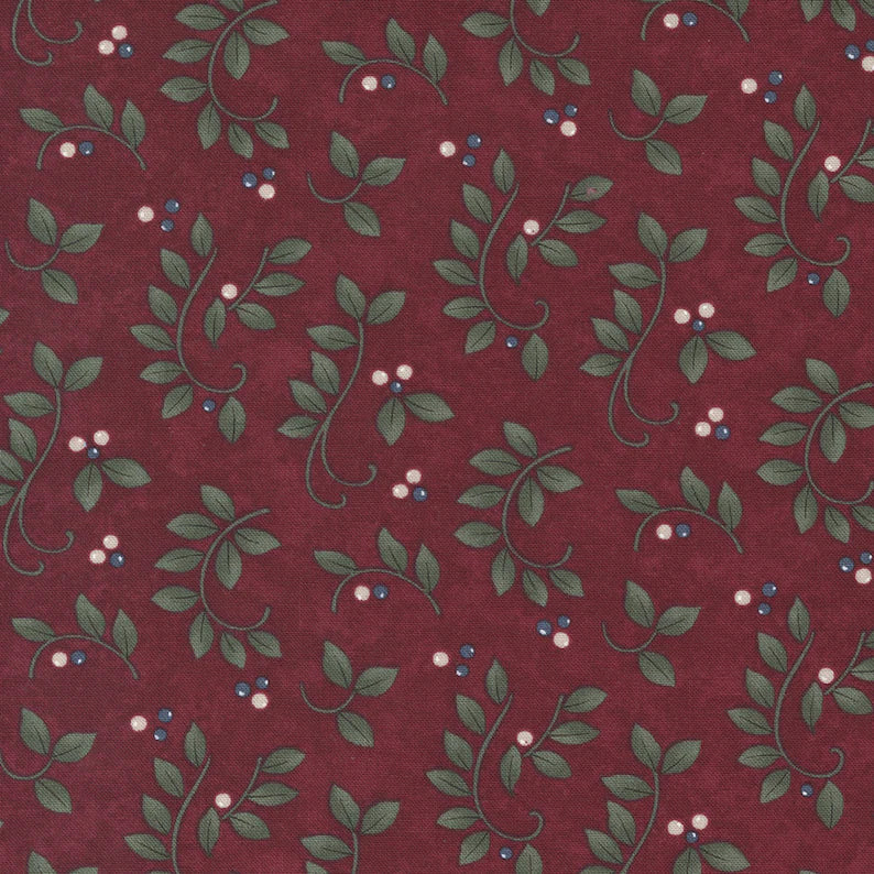 This fabric is a deep maroon with leaf swirls and white little berries. Beautiful winter fabric 100% Cotton, 44/5"