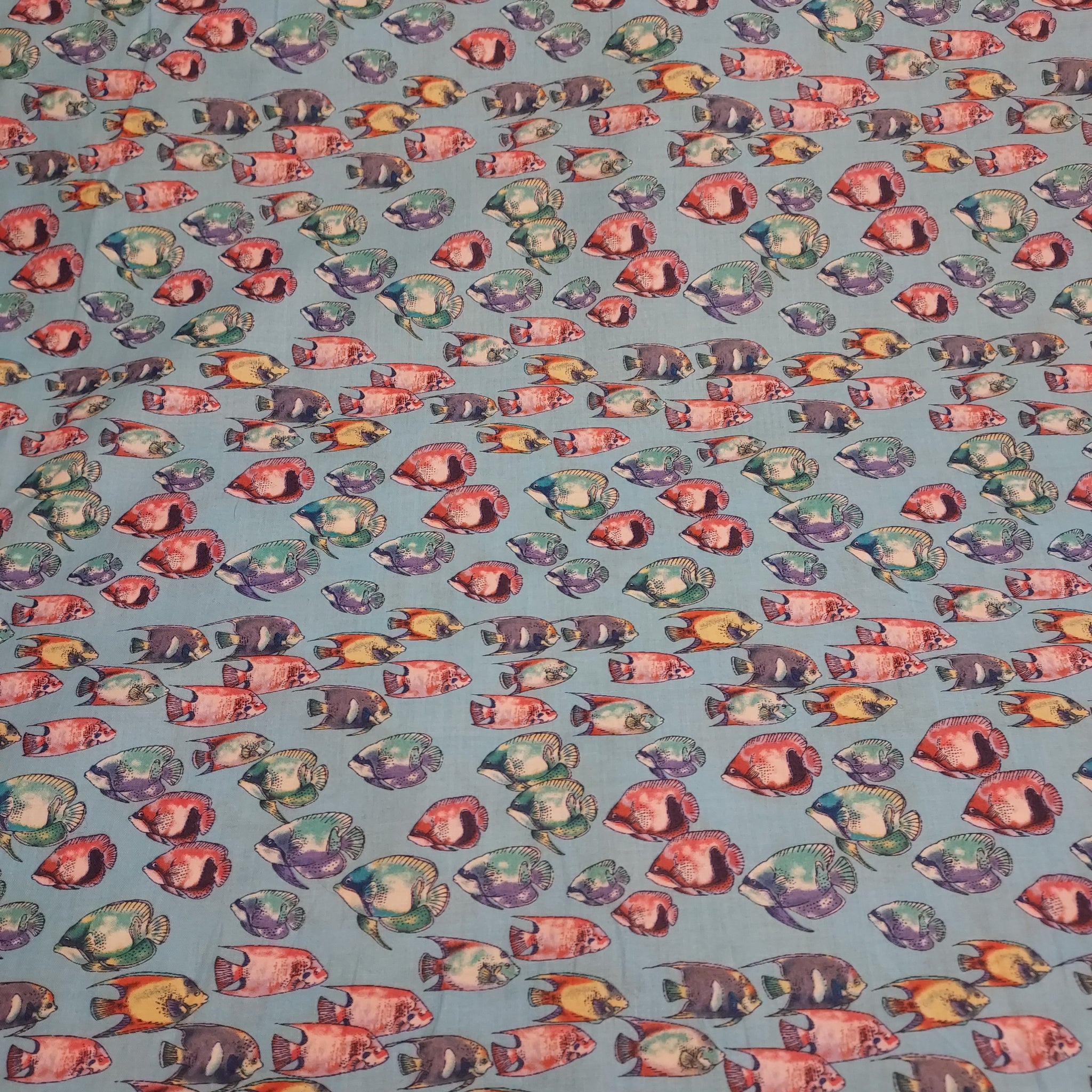 Fishy printed cotton. Thin enough to be considered cotton lawn, but can also be used for quilting. Would be great for pajamas or a light beach cover. Colorful fish on a bright blue background.   100% Cotton  44"