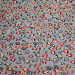 Fishy printed cotton. Thin enough to be considered cotton lawn, but can also be used for quilting. Would be great for pajamas or a light beach cover. Colorful fish on a bright blue background.   100% Cotton  44"