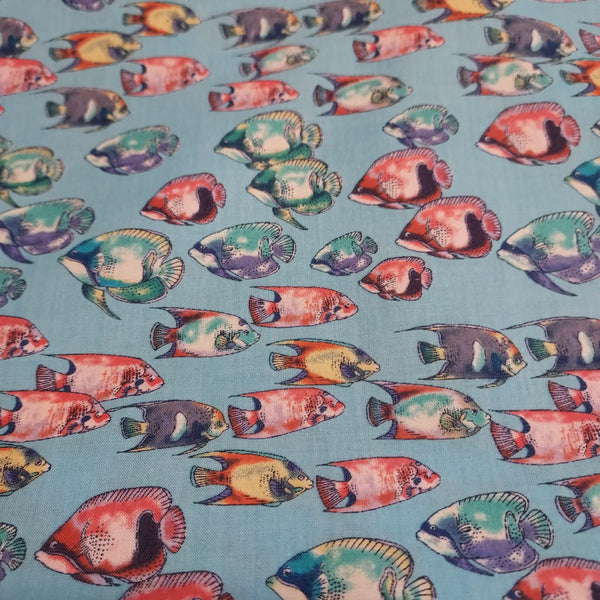 Fishy printed cotton. Thin enough to be considered cotton lawn, but can also be used for quilting. Would be great for pajamas or a light beach cover. Colorful fish on a bright blue background.   100% Cotton  44"