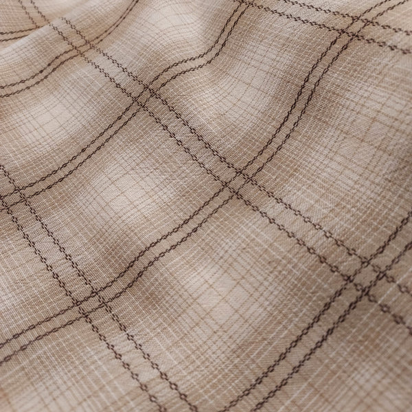 This beautiful woven fabric is made in Japan. Featuring a textured weave, this plaid is beige, cream and brown. Could quality for top or bottom weight. 