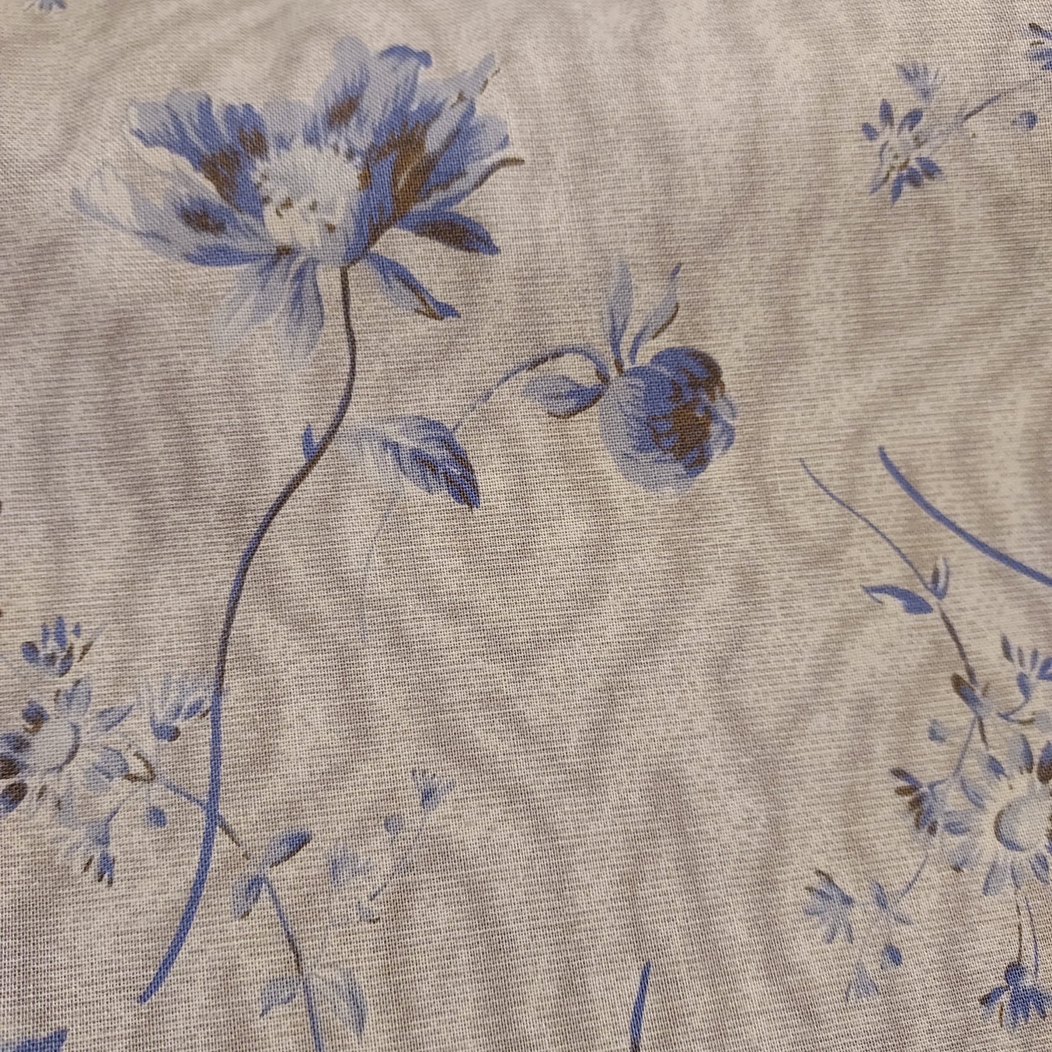  This beautiful cotton fabric is made in Japan. Super soft hand and lightweight feel, this fabric has big blue flowers on a tan background. This tan color has a little bit of a green tint to it. Beautiful fabric for clothing or quilting.