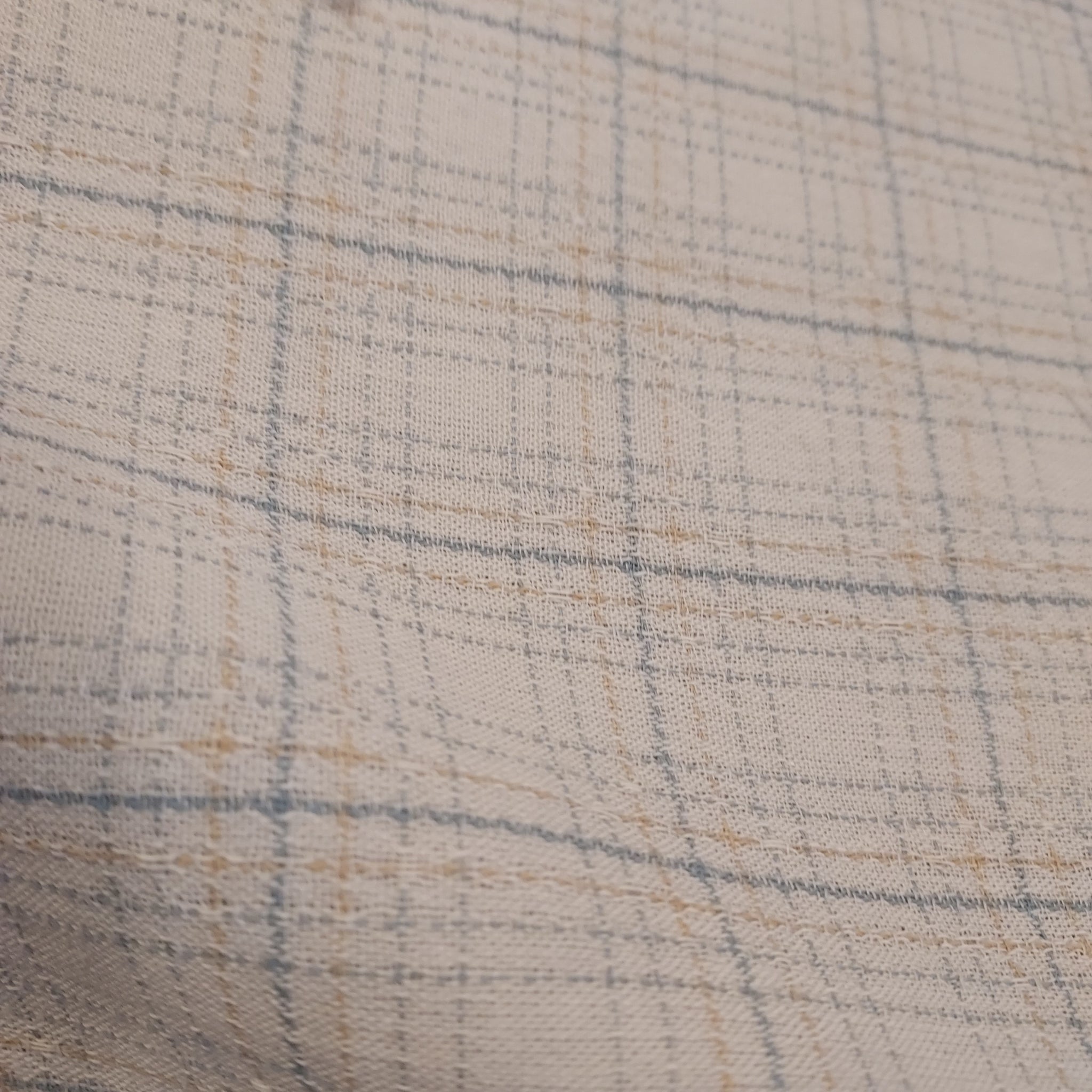 This beautiful woven fabric is made in Japan. Featuring a textured weave, this plaid is cream with light blue lines throughout. Suitable top or bottom weight. 100% Cotton, 44" wide.