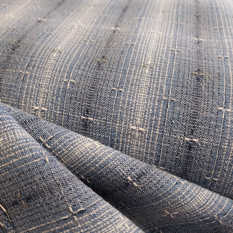 This beautiful woven fabric is made in Japan. Featuring a textured weave, this plaid is blue with navy blue and beige lines throughout. Suitable top or bottom weight. 100% Cotton, 44" wide.
