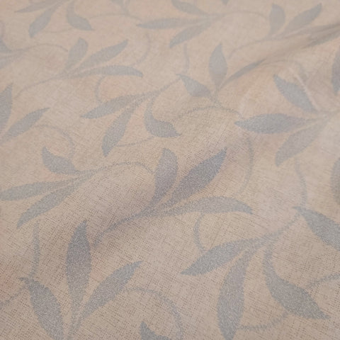 This beautiful cotton fabric is made in Japan. Soft hand and lightweight feel, this fabric has wispy pale blue leaves over a tan background. This background has a visual texture that is apparent the closer you get. 