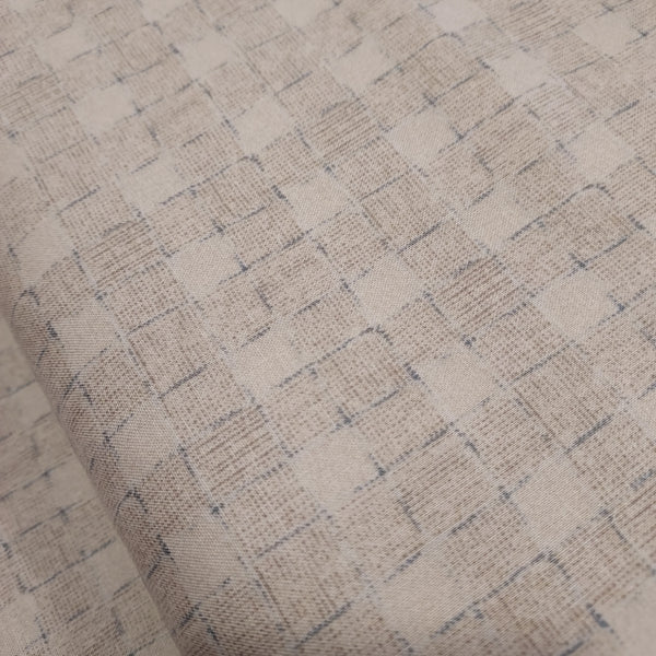 This beautiful cotton fabric is made in Japan. Soft hand and lightweight feel, this fabric has a light taupe background with a taupe and blue grid pattern on top. The grid pattern almost looks like a loose basket weave. This fabric is beautiful and would be suitable for quilting or apparel sewing.   Variant style (CE10472S-A)