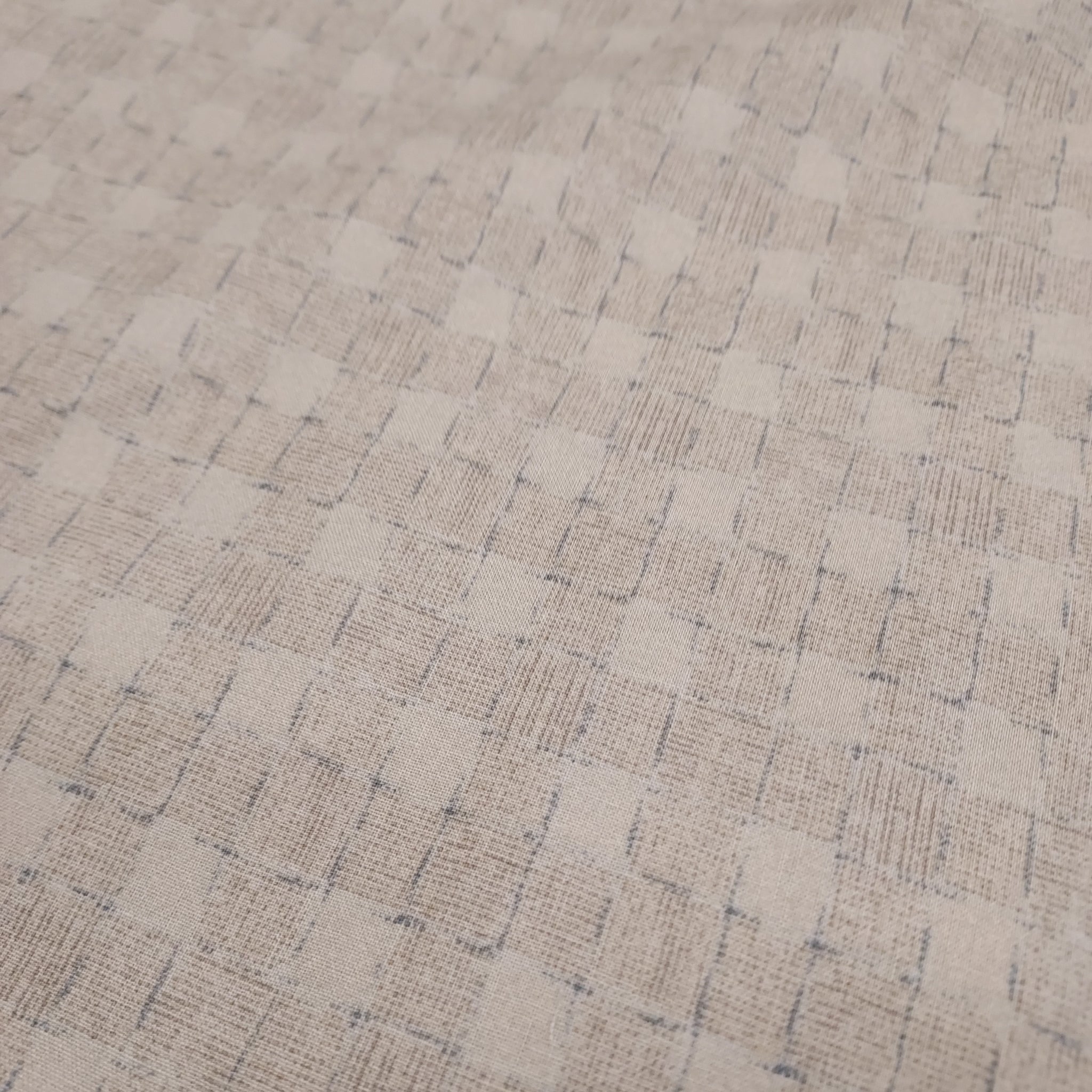 This beautiful cotton fabric is made in Japan. Soft hand and lightweight feel, this fabric has a light taupe background with a taupe and blue grid pattern on top. The grid pattern almost looks like a loose basket weave. This fabric is beautiful and would be suitable for quilting or apparel sewing.   Variant style (CE10472S-A)