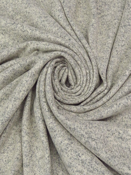 ﻿This is a heathered brushed sweater knit that is 58" wide. It is a rayon blend with 79% rayon/17% polyester/4% lycra. The color is a pale ash heather, and it has a 4 way stretch that is 70% selvage to selvage. IT has a fuzzy hand and is super cozy. 