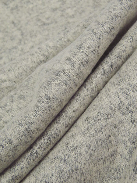 ﻿This is a heathered brushed sweater knit that is 58" wide. It is a rayon blend with 79% rayon/17% polyester/4% lycra. The color is a pale ash heather, and it has a 4 way stretch that is 70% selvage to selvage. IT has a fuzzy hand and is super cozy. 