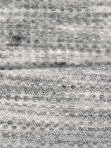 ﻿This is a heathered brushed sweater knit that is 60" wide. It is a polyester and lycra blend. The color is a heathered grey and black with some lighter grey. It has a 4 way stretch that is 70% selvage to selvage. Fuzzy hand which makes it super cozy. 