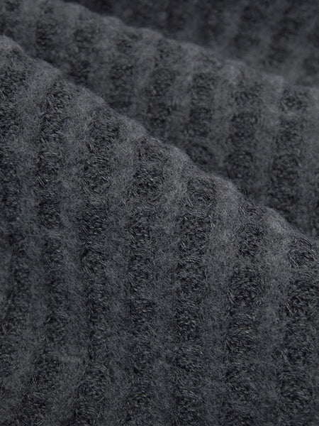 ﻿This sweater knit is a heathered brushed waffle. Super soft fabric that has a decent thickness. This fabric is 50" wide and is a polyester, rayon, lycra blend. It also has a 4 way stretch that is 50% selvage to selvage. This fabric would make the comfiest lounge set! 