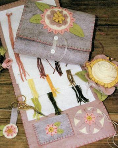 This set is made entirely from wool felt or felted wool. Three dimensional flowers are easy and fast to make. The floss holder opens up and sew in rings hold cut strands of floss. The cute pincushion is super fun and fast to make. Also included is a fun scissors fob. Finished sizes: Floss keeper: 7 in x 17 in (open); pincushion 4 in wide x 3 in tall