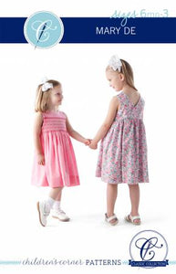 Mary De is the classic wrap-in-the-back sundress and jumper creating a V-back. The dress fastens with two buttons, and the bodice is lined. In addition to the original smocked dress, Mary De can also be made with a smocked insert or unsmocked with a plain front bodice. Our easy-to-follow smocking instructions will make this your favorite smocking project. The unsmocked version is great for beginners and the smocked versions are for more advanced sewists.