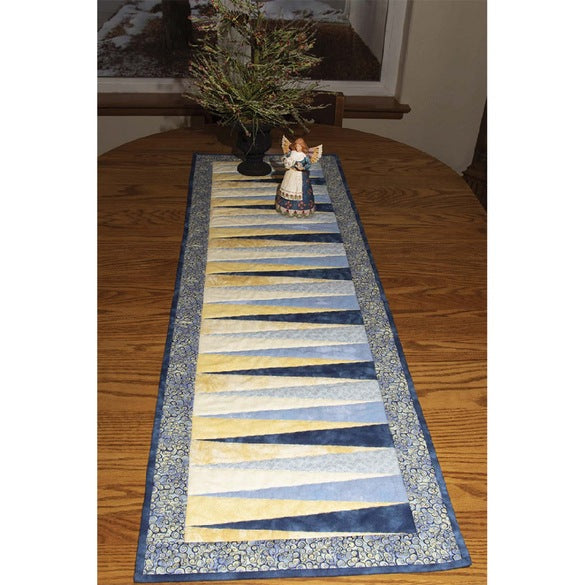 Decorate your dining table, end tables, or accent tables with this Zig-Zag Runner Pattern from Cut Loose Press and Cheryl Phillips. This fat quarter friendly project is ideal for confident sewists who want to broaden their skills. Choose various prints and colors to make a Zig-Zag Runner for every season. The finished Zig Zag Runner Pattern measures approximately 16-1/2" x 55". Included with the design is a full set of instructions and a list of fabric requirements.