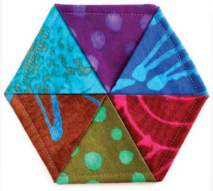 Need a hostess gift or a little something for a special someone? Why not make a set of these Hexie Twist Coasters? These are simple enough to get the whole family involved. When you turn them right side out, the kids will be amazed! Want to make a hot pad instead? No problem - just insert a piece of Insul-Bright batting in place of the template plastic and increase the template to eight inches. Don't you love a pattern with option potential???