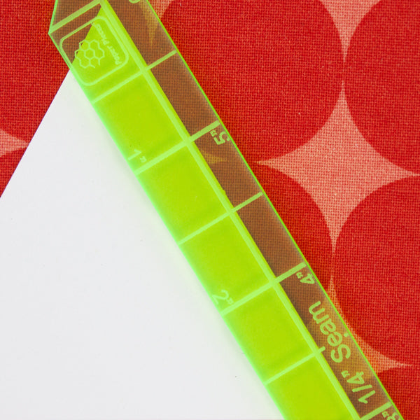 Easily choose between a 1/4" and 3/8" seam allowance using this handy 6" ruler! Simply line up the center line against your Paper Piece, and cut on the outside of the ruler. The pointed ends allow you to bevel your corners, reducing bulk.