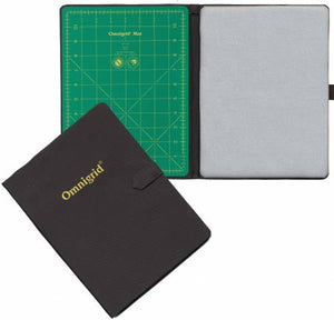 Omnigrid FoldAway is a portable cutting and pressing station. The gridded cutting mat is 8-3/4in x 11-3/4in and the non-stick ironing surface is 8-3/4in x 11-3/4in are side by side. It can be used on any work surface and great for trimming foundation piecing or cutting around templates. Use both sides, or fold one under. It folds for convenience, small size fits in travel or tote bag, easy storage and has handles for easy carrying. 