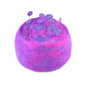 The Wooly Bun Pincushion is felted from 100% wool. Each pincushion is unique. The handcrafted pincushion is 4 inches in diameter and 2 inches tall. It makes a lovely addition to your sewing space or a cherished gift.
