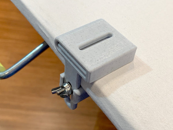 Making binding is easy with the 3rd Hand Binding Clip. It is adjustable so it fits a standard ironing board as well as thinner boards. No tools necessary, just loosen the wing nut, slide the 3rd Hand Binding Folder Clip into place and turn the wing nut to secure it in place.